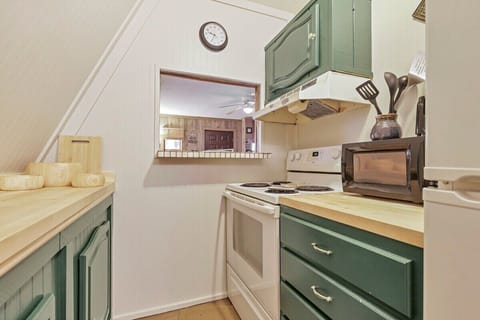 Kitchen is equipped with an electric range, microwave and a fridge