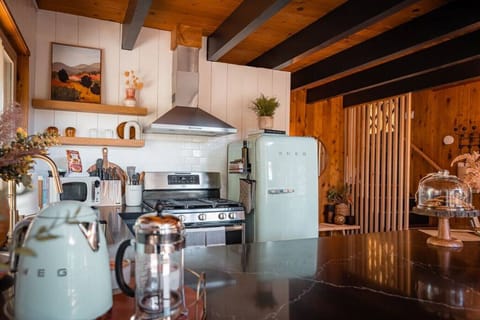 Kitchen: Whip up your favorites in this sleek, retro-inspired kitchen with modern flair!