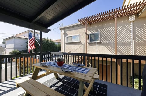 Balcony with stairs to exit property. Balcony includes barbecue & eating area.