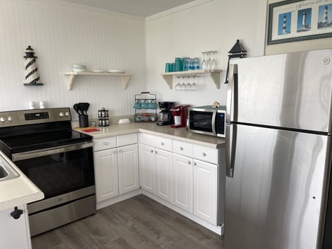Well stocked kitchen with most anything you need to prepare and serve a meal.