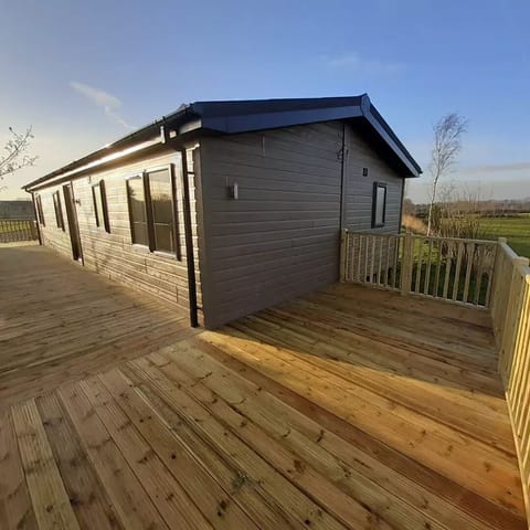 Decking at the side and rear of the lodge.