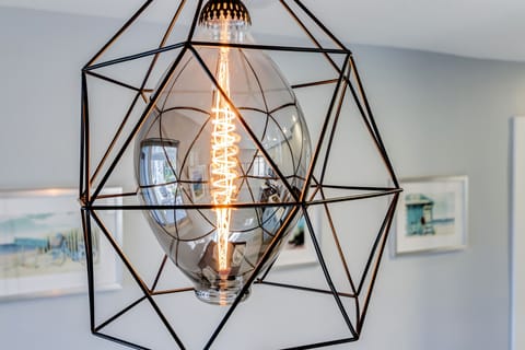 Farmhouse-style lighting illuminates the open space