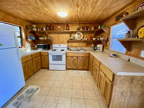 On the Rocks - A super rustic river shack kitchen decorated with antiques.