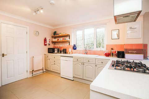 Open plan kitchen with coffee machine, for social living and dining