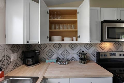 Kitchen (cabinets, microwave, sink, and stove)