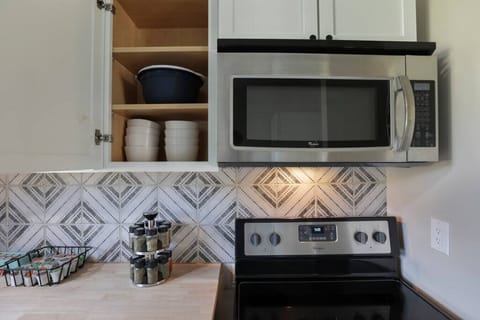 Kitchen (cabinets, microwave, and stove)
