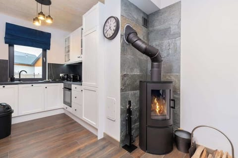 Kitchenette with oven and refrigerator. 