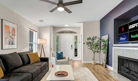 Spacious and comfortable living room with fireplace and large smart tv