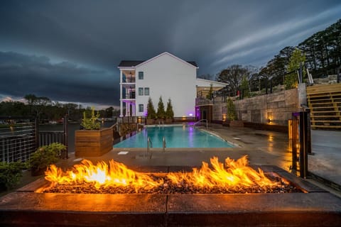 This stunning property features shared areas, including this fairy tale fire pit with surrounding seating, infinity pool, and lounge chairs.