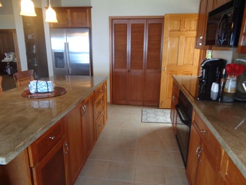 The louvered doors conceal a fully stocked pantry with many handy appliances at your fingertips