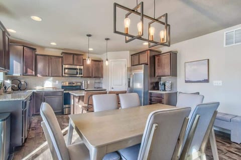 Create Culinary Delights in Our Well-Equipped Kitchen and Share Memorable Meals at the Gorgeous Dining Table. Bask in the Spaciousness and Beautiful Lighting for an Exceptional Dining Experience.