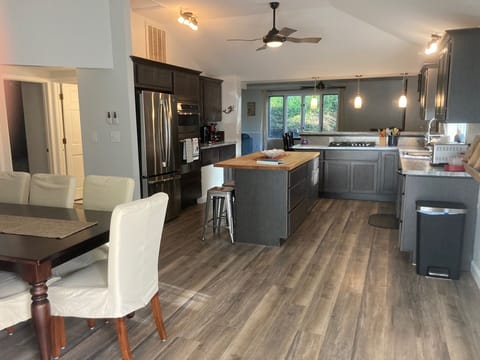 View of eat-in kitchen with full dining set, kitchen island, and updated kitchen