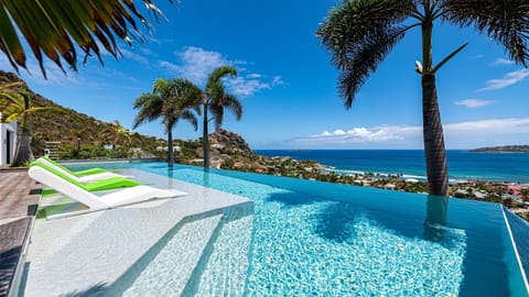 An infinity pool, a heated pool, sun loungers