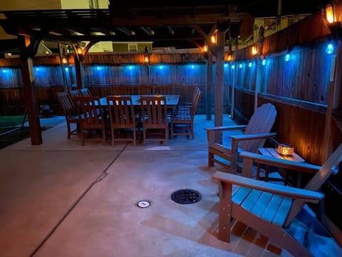 Backyrd Patio w/ a large table that has seating for 12 and mood lighting for the perfect ambience!