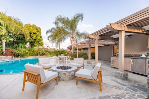 Outdoor fireplace creating a cozy poolside vibe