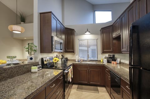 The open kitchen with plenty of storage and all new black appliances