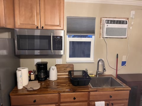 Fridge, microwave, coffee/tea maker, cookware/dishes/utensils