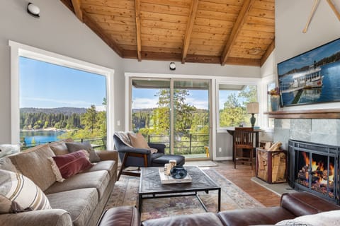 Great room with lake views, access to  master deck, and decorative fireplace