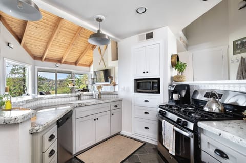 kitchen, gas stove, two coffee makers (drip and Keurig), dishwasher, microwave