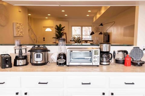 Enjoy our FULLY stocked kitchen which includes an air fryer, blender, toaster, instapot (that also functions as a slow cooker and rice cooker), waffle maker, food processor, electric mixer, electric kettle, coffee maker, and milk frother!