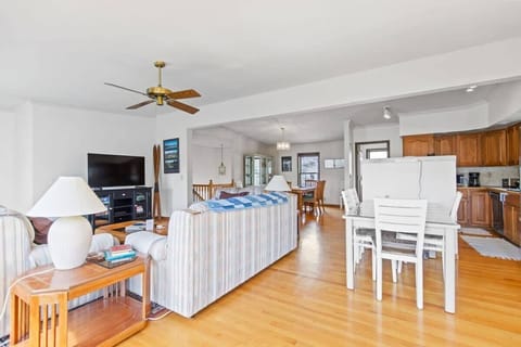 The view from the game table highlights the close proximity between the living, kitchen and dining areas in this bright and beautiful home.