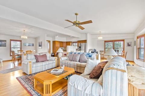 This bright and beautiful, open-concept living/kitchen/dining area offers up ample comfort with three couches, a coffee table, a flat-screen TV and plenty of puzzles and games for added fun.