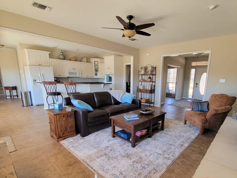 From the den, you can see the open kitchen with bar seating.