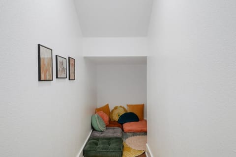 Adorable and colorful pillows & sitting cushions in the reading nook.