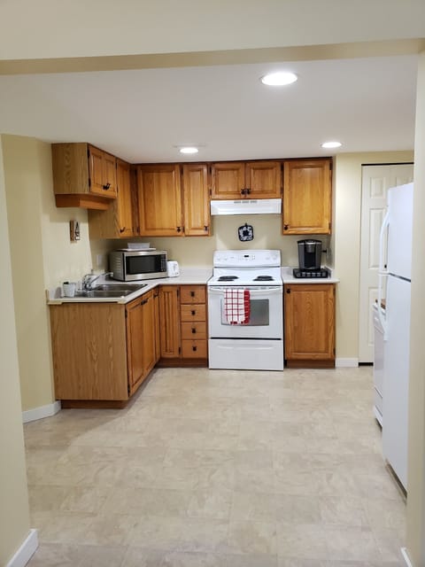 Kitchen with stove, microwave, Keurig coffee maker, fridge and dishwasher.