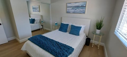 Seascape-inspired bedroom with queen bed