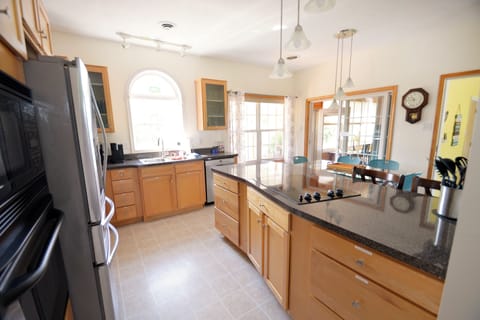 Kitchen with a cook top and modern appliances