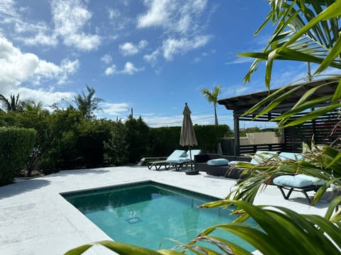 Private pool and covered Gazebo area pool chairs, umbrellas, and sectional. 