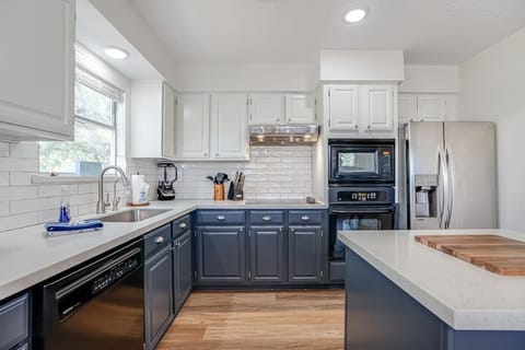 Fully stocked kitchen with blender and toaster.