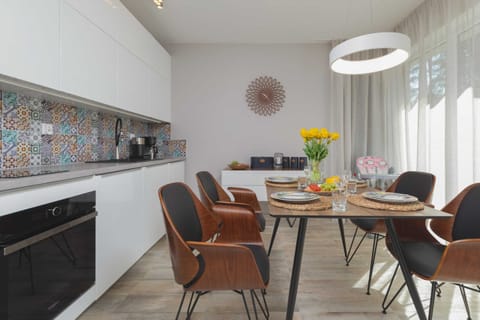 Kitchenette and dining table with tableware.