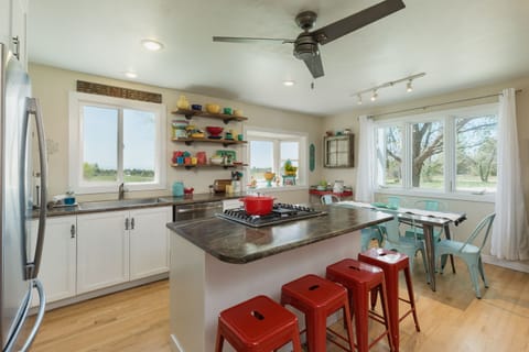 Fully stocked kitchen with seating for 10.