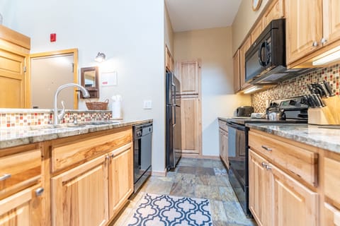 Full-sized kitchen with updated appliances and granite countertops.