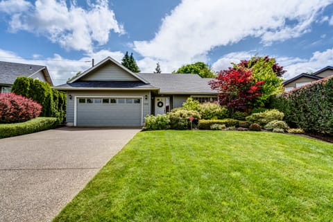 Welcoming entry of quiet Ferry Street Bridge home with pristine landscape