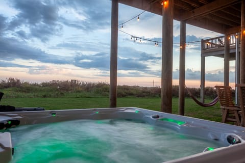 Watch the gorgeous ocean sunsets from your 7 person hot tub. And during the day your family can enjoy it under the shade of the house while watching the game on TV.