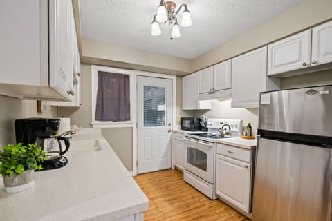 The fully-equipped kitchen includes a new Bosch dishwasher and full cooking supplies including blender, coffee maker, French press, microwave, crock-pot, cooking pots and pans, toaster, and more.