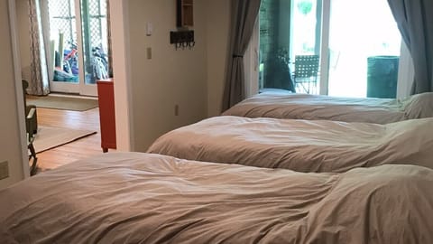 Four twin beds in separate sleeping area in basement