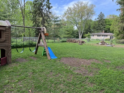 Fenced in yard with playground