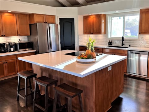 Renovated kitchen with stainless steel appliances, coffee station & large island