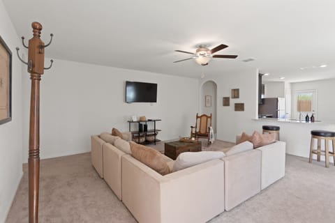 Relax in the bright living room with comfy seating, smart TV, and open layout perfect for gathering.