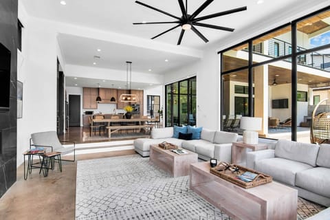 Large living room with floor to ceiling windows providing excellent waterfront views.