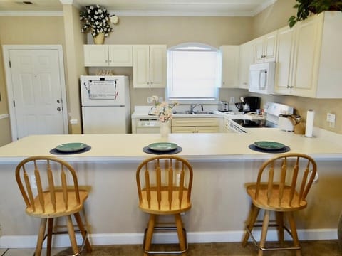 Fridge, stovetop, dishwasher, coffee/tea maker