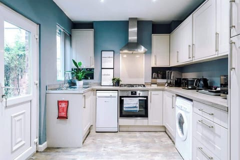 Tidy and Fully Equipped Kitchen ready for meal preparation. The property has rangehood ventilation, an oven with stovetop, a Nespresso machine, microwave, dishwasher plus dining and cooking utensils.