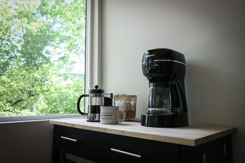 Coffee bar featuring a drip coffee maker and French press.