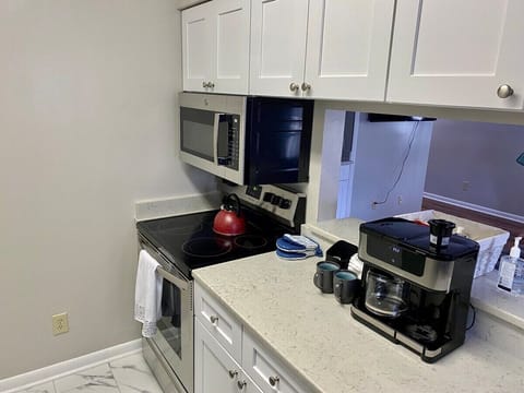 Fridge, stovetop, dishwasher, coffee/tea maker