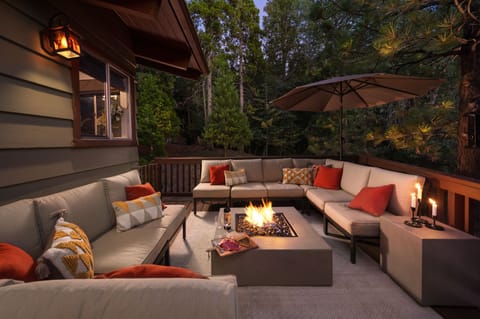 Enjoy the enchanting outdoor forest lounge with firepit and seating for 12