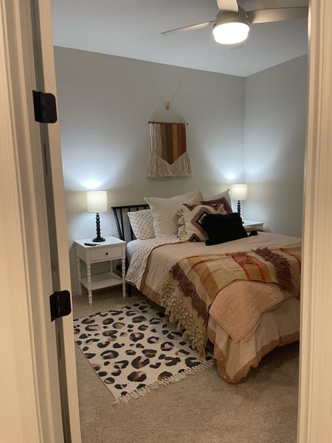 Guest bedroom- queen bed, walk-in closet, fan, TV